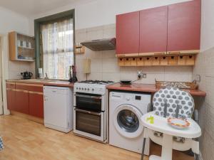 a kitchen with a washing machine and a dishwasher at 382 on the Bay in Morecambe