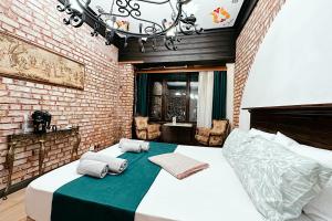 a bedroom with a large bed in a brick wall at The Haliç Bosphorus in Istanbul