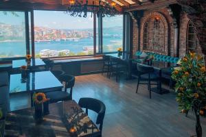 a restaurant with tables and chairs and a view of the water at The Haliç Bosphorus in Istanbul