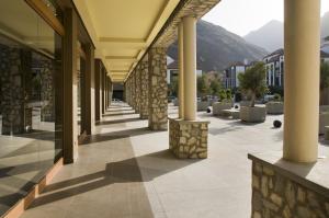 a hallway of a building with columns and mountains at Hotel Playa Calera in Valle Gran Rey