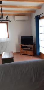 a living room with a television and a table at La Pitchounette in La Colle-sur-Loup