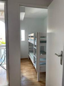a room with a room with bunk beds in it at Studio cabine barcares in Le Barcarès