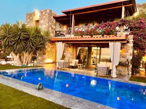 a swimming pool in front of a house at Great view stone house private pool! in Bodrum City