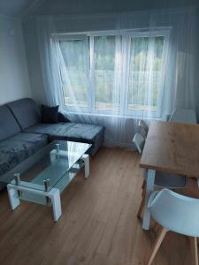 a living room with a couch and a table at Domek w Gruszkach in Gruszki +16 photos