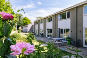 a building with pink flowers in front of it at Atlantic Reach Resort in Newquay