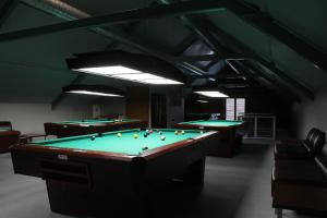two pool tables in a room with billards at LUNA Marijampole in Marijampolė