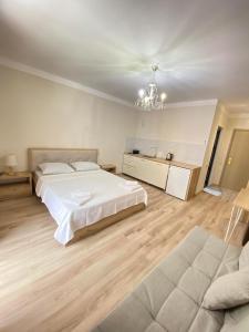 a large bedroom with a bed and a couch at Panorama Bajo Shekvetili in Shekvetili