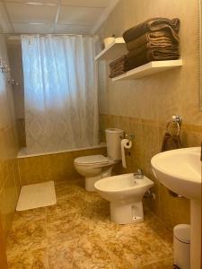 a bathroom with two toilets and a sink and a shower at Family Apartment in Orihuela