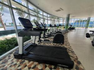 a gym with a row of tread machines in a building at Azure North San Fernando Pampanga in San Fernando