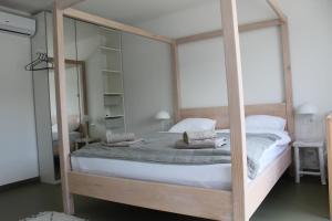 a bedroom with a canopy bed with a mirror at Landhaus Anton in Žakanje