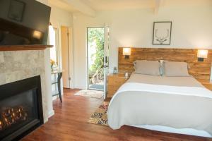 a bedroom with a bed and a fireplace at Inn at Buckhorn Cove in Little River