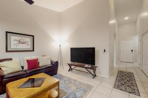 a living room with a couch and a flat screen tv at Tucson National #8689 in Tucson