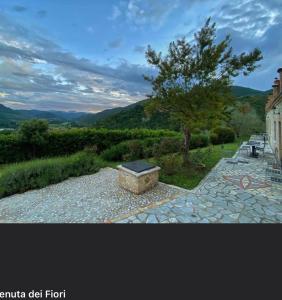 a box sitting on a stone walkway next to a tree at La Tenuta dei Fiori in Ferentillo