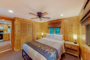 a bedroom with a bed and a ceiling fan at Tumblehome Cabin in Rangeley