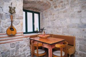 a dining room with a wooden table and a guitar at Apartment Galeriana Palace by Litto in Split +55 photos