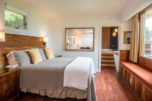 a bedroom with a large bed and a bathroom at Inn at Buckhorn Cove in Little River