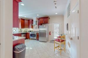 a kitchen with a stainless steel refrigerator and a table at Granite Tranquility in Yosemite West