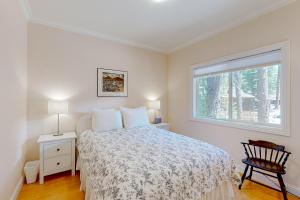 a bedroom with a bed and a window and a chair at Granite Tranquility in Yosemite West