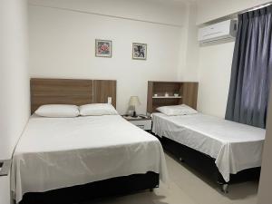 מיטה או מיטות בחדר ב-Condominio Las Palmas II VILLA FATIMA