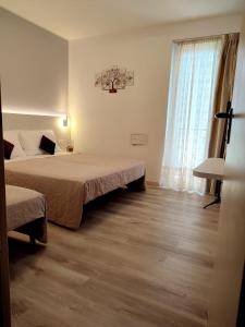 Postel nebo postele na pokoji v ubytování Hotel Madera