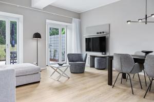 a living room with a couch and a table with chairs at Strandresidenzen Binz-Prora Strandresidenzen Binz-Prora V0 2 in Binz