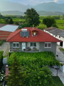 a house with a red roof with a yard at Xrysa's House in Aridaia