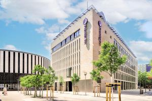 un edificio con un reloj al costado. en Premier Inn Dresden City Prager Straße en Dresden