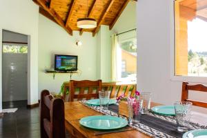 a dining room with a wooden table with blue plates on it at Altos Del Molino in Trevelín