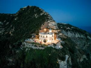 a building on the side of a mountain at Faro Punta Imperatore in Ischia