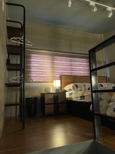 a room with two bunk beds and a table with a ladder at 1 bedroom Apartment (Industrial Loft) in Angeles
