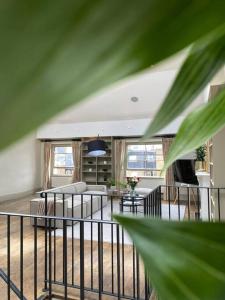 a living room with a couch and a table at Top floor luxury 3 bedroom near Baker St in London