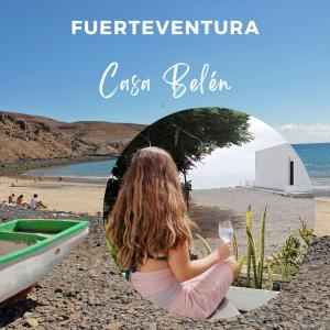a little girl sitting in a boat on the beach at Casa Belén in Pozo Negro