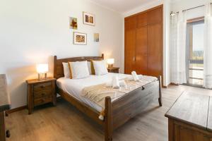 ein Schlafzimmer mit einem großen Bett und zwei Nachttischen in der Unterkunft Seaside Deluxe Flat in Peniche