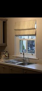 uma cozinha com um lavatório e uma janela em Bunratty Castle Gardens em Bunratty