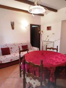 a living room with a table and a couch at Il CASALE NELLA TUSCIA. BIOFARM. Casa nel Giardino in Viterbo