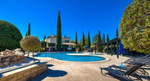 a swimming pool in a yard with trees at Apartment N3 Kallithea in Kouklia