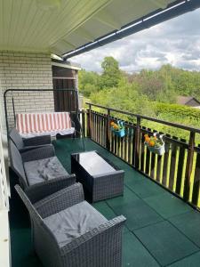 a balcony with two chairs and a table on a porch at Swden Sunne in Sunne