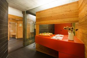 a bathroom with a red counter and a shower at Familienhotel Mateera Gargellen / Montafon in Gargellen +87 photos