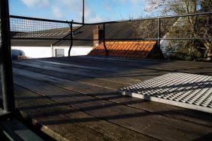 a tennis court with a fence on top of it at Kess Maison, Gehele villa met dakterras Enschede in Enschede