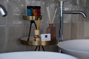 a bathroom with a toilet and a shelf with some bottles at Kess Maison, Gehele villa met SAUNA en dakterras Enschede in Enschede +13 photos