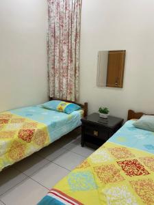a bedroom with two beds and a mirror and a window at Magnolia homestay 2 
