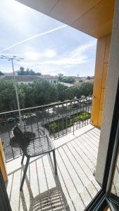 a balcony with a chair and a view of a city at Apolo71 Alojamentos in Bragança