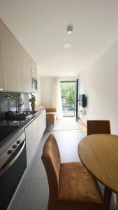 a kitchen with a table and a dining room at Apolo71 Alojamentos in Bragança