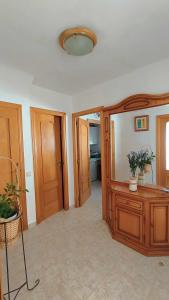 a living room with a table and a mirror at Pareada con piscina privada y con vistas in Comarruga