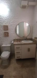 a bathroom with a toilet and a sink and a mirror at Aqua Marina Resort in Trementino