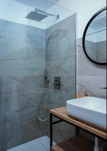 a bathroom with a sink and a mirror at Chata ŠENKÁRKA Zuberec in Zuberec