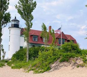 a house with a lighthouse on top of a beach at The Loft at Little Bear in Frankfort