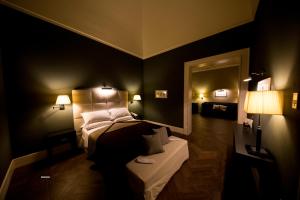 a dark room with a bed and a mirror at Relais Il Santissimo in Turi