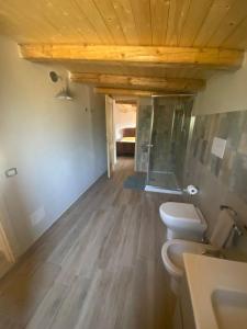 a bathroom with two toilets and a wooden ceiling at Lovely Country House in Trappeto