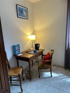 a room with a desk with a lamp and a chair at la vallee in Plogoff +16 photos